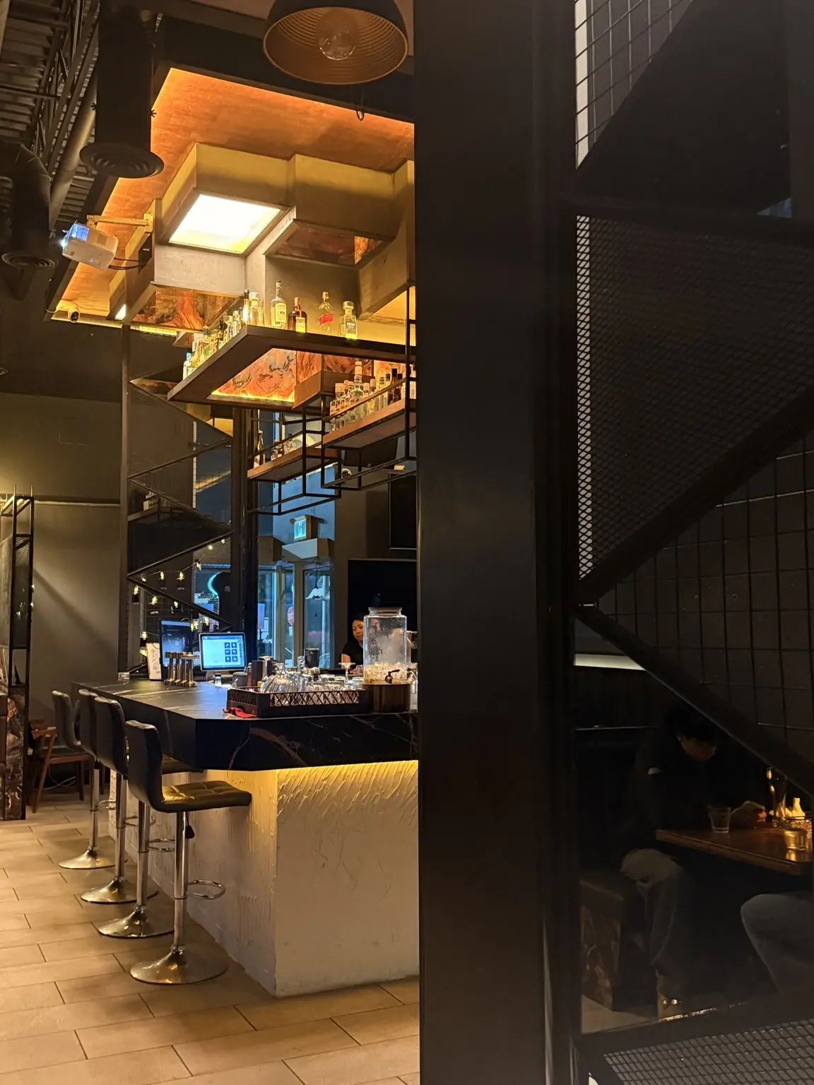 Bar seating and an intimate booth inside Hotferno